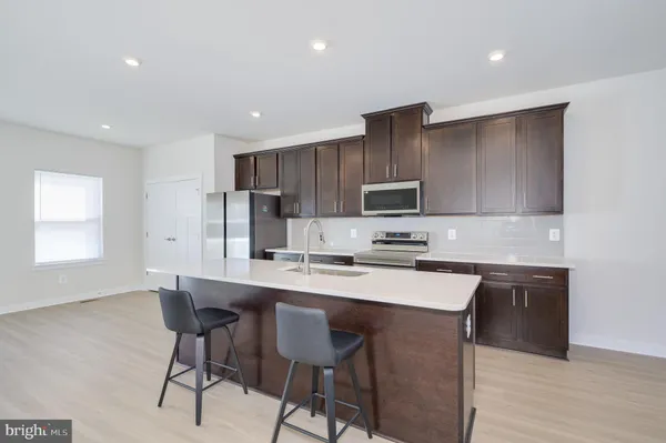 a kitchen with kitchen island cabinets and refrigerator