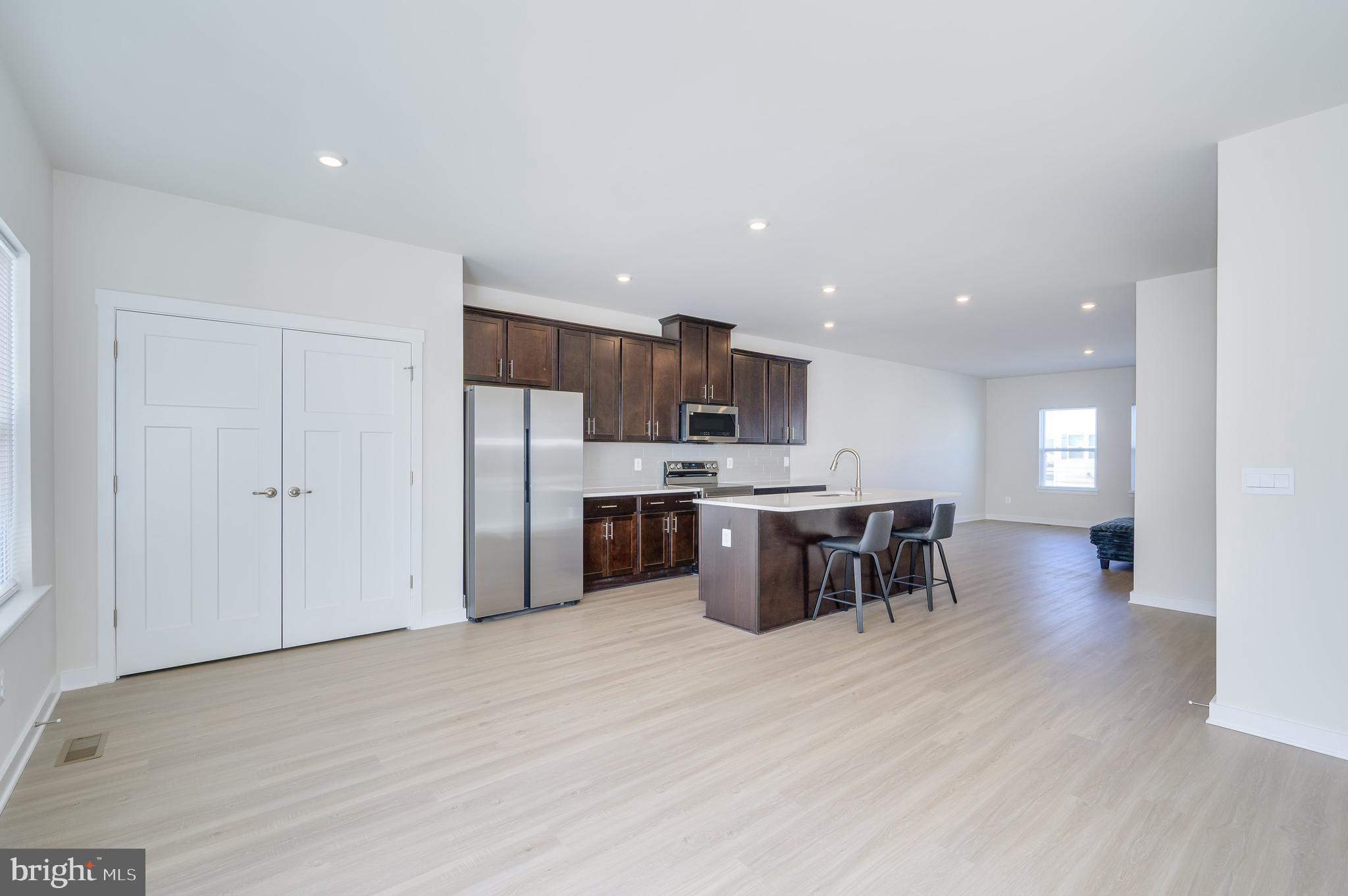 14 Trotting Road Inwood, WV 25428 - Photo 33 of 53 a kitchen with stainless steel appliances kitchen island granite countertop a refrigerator a stove a sink a dining table and chairs