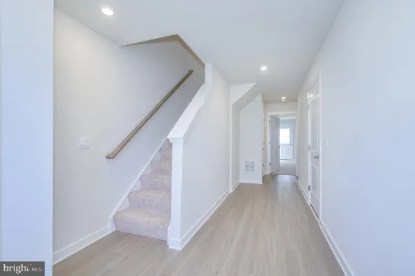 a view of a small space with wooden floor and a window