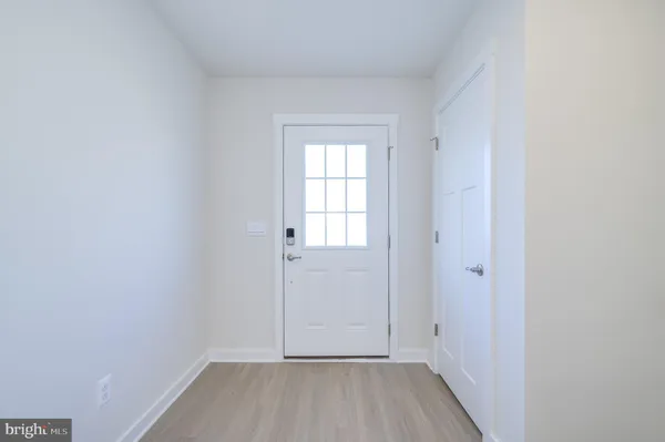 a view of hallway with wooden floor