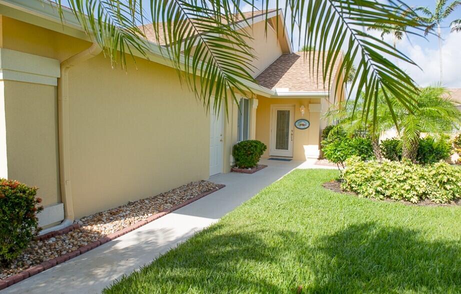 114 Beach Summit Court Jupiter, FL 33477 - Photo 1 of 32 a front view of a house having yard
