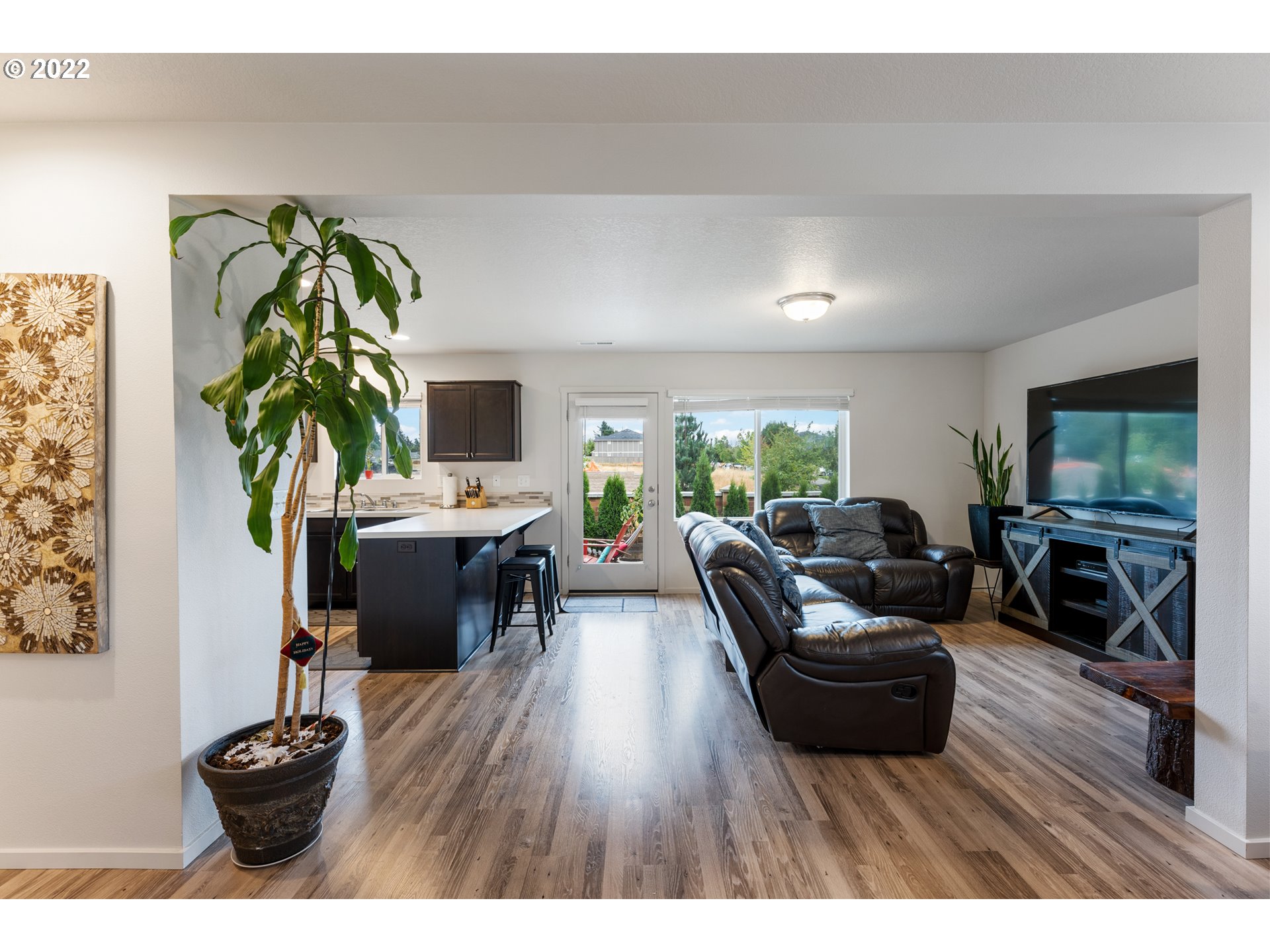 2256 South Meadowlark Dr. Ridgefield, WA 98642 - Photo 6 of 32 a living room with furniture a wooden floor and a potted plant