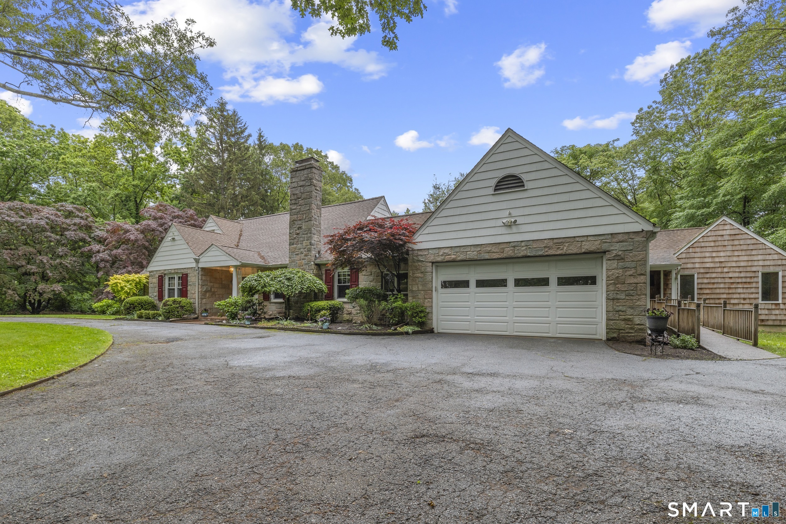 190 East Rocks Road Norwalk, CT 06851 - Photo 3 of 38 a front view of a house with a yard and garage
