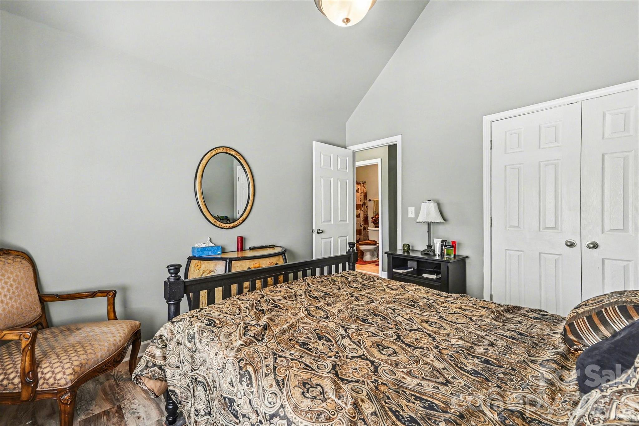 10812 Clark Street Davidson, NC 28036 - Photo 17 of 32 a bedroom with a bed a dresser and chair