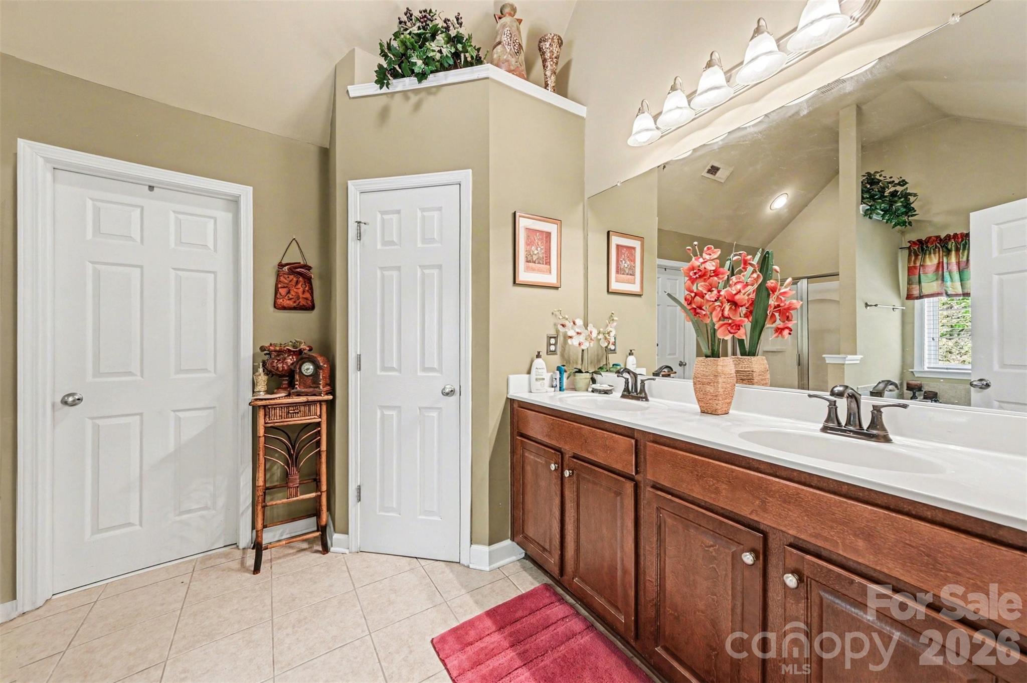 10812 Clark Street Davidson, NC 28036 - Photo 24 of 32 a spacious bathroom with a sink vanity and a mirror