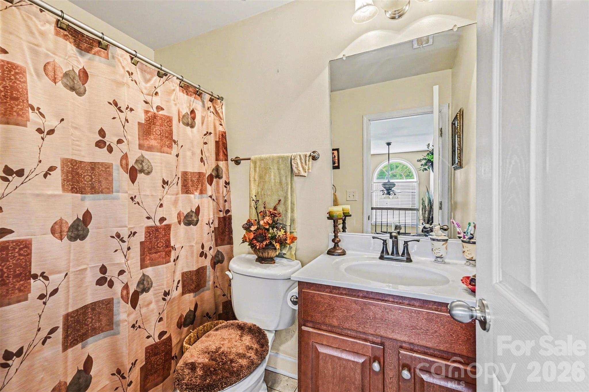10812 Clark Street Davidson, NC 28036 - Photo 26 of 32 a bathroom with a sink toilet and shower