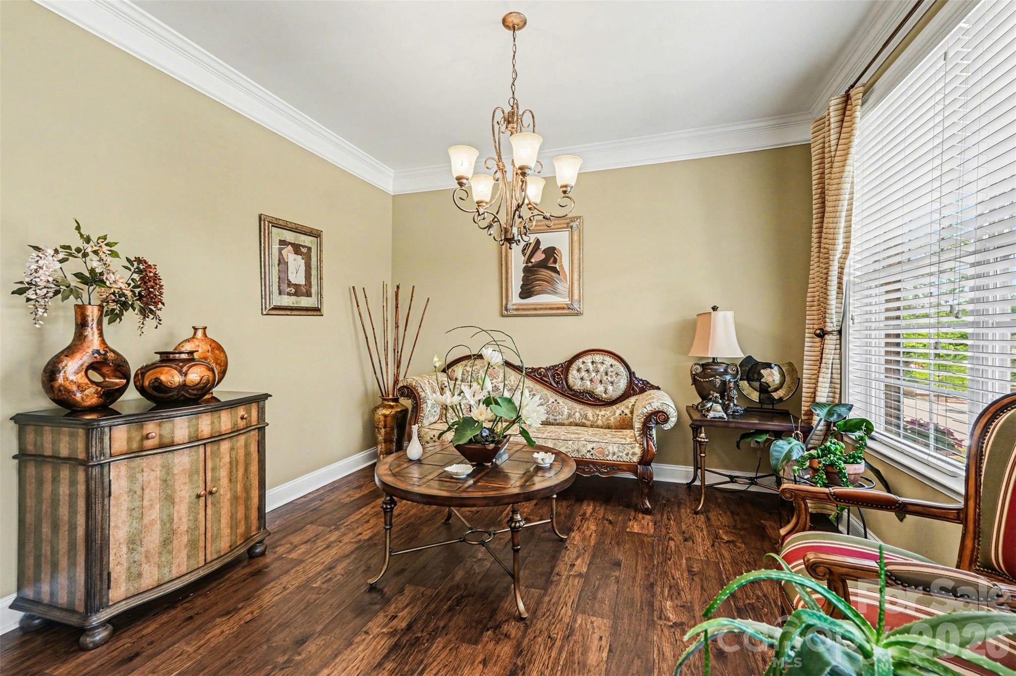 10812 Clark Street Davidson, NC 28036 - Photo 7 of 32 a view of a dining room and livingroom with furniture wooden floor a chandelier