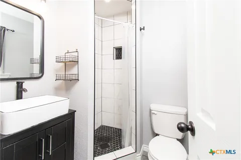 a bathroom with a toilet sink and shower