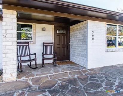 a view of front door of house with seating space
