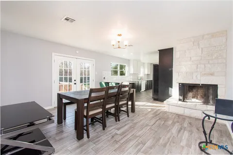 a view of a dining room with furniture and a fireplace