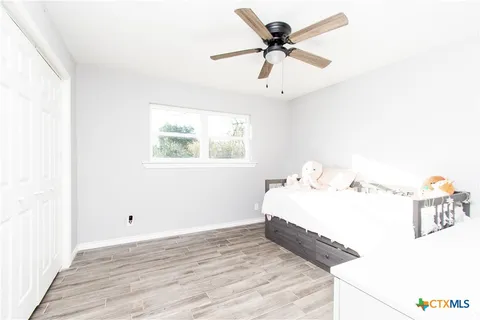 a bedroom with a bed and a chandelier