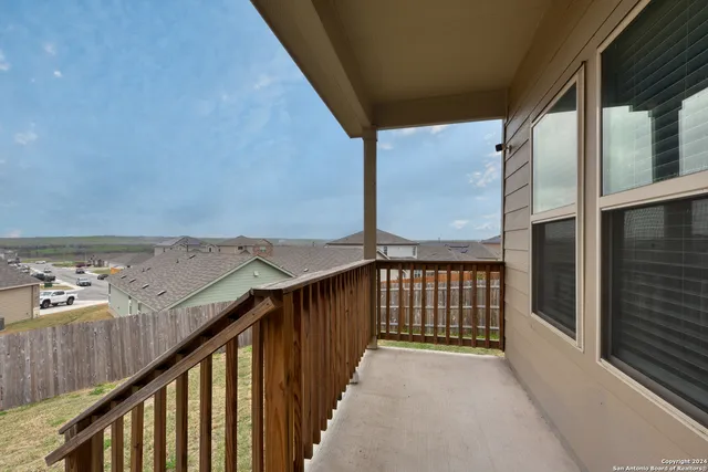 a view of a balcony with furniture