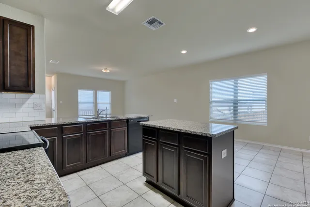 a kitchen with stainless steel appliances granite countertop a sink and stove