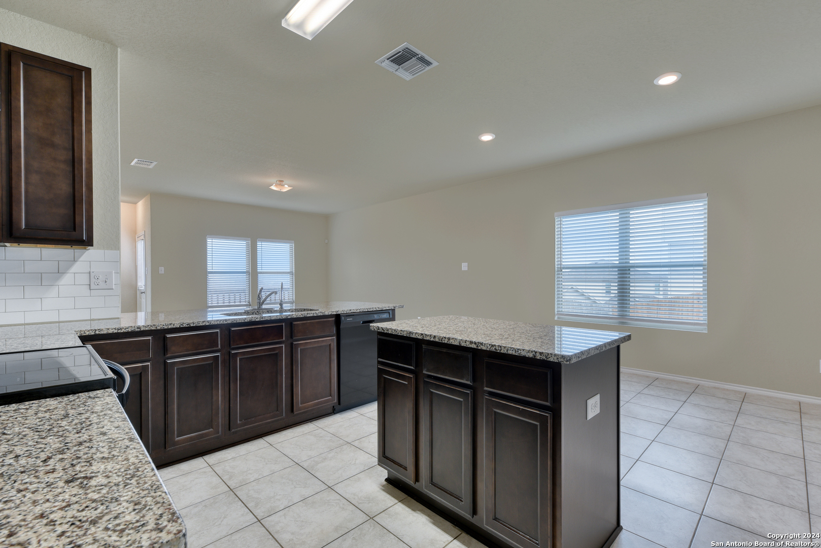10546 Midsummer Meadow Converse, TX 78109 - Photo 5 of 18 a kitchen with stainless steel appliances granite countertop a sink and stove