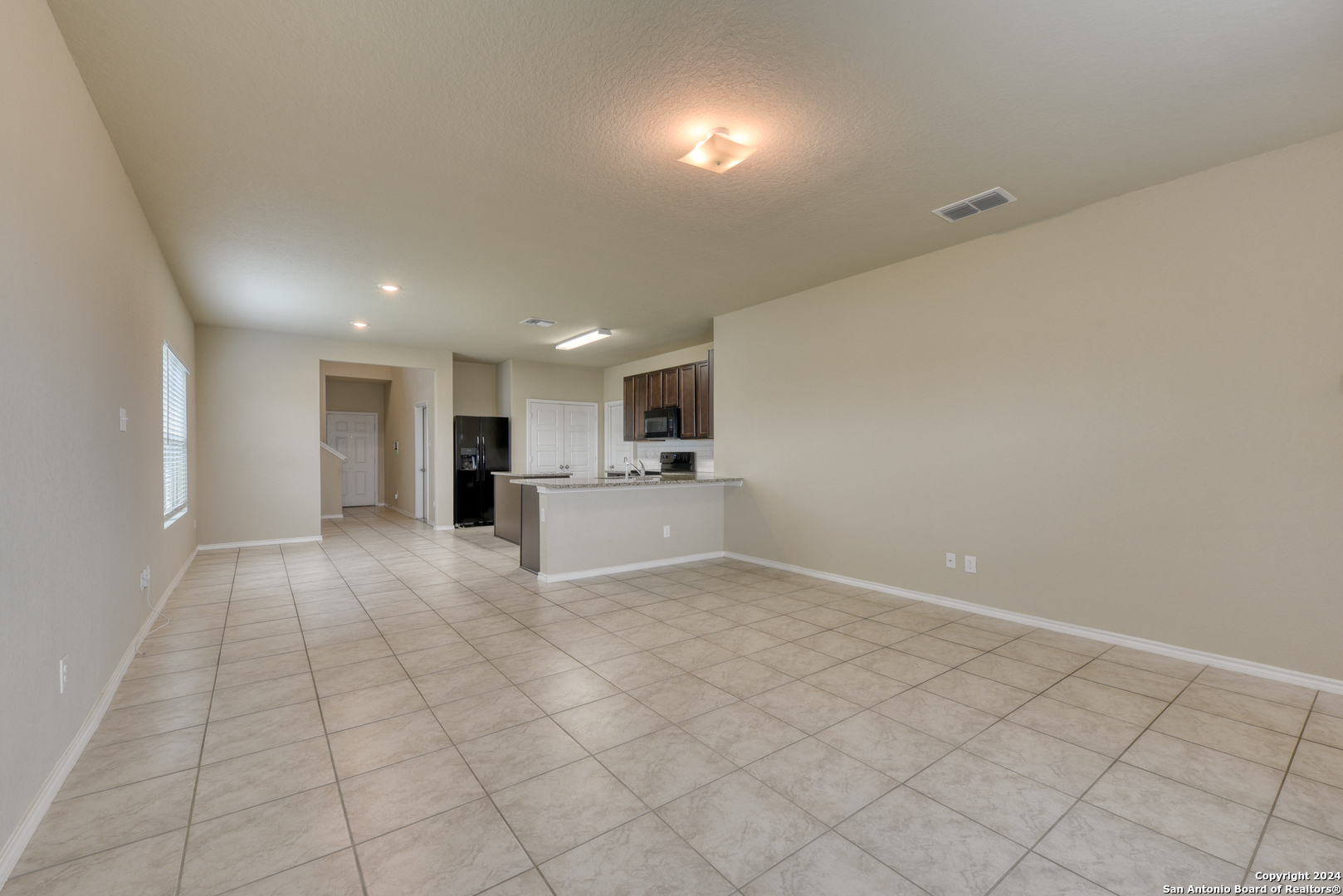 10546 Midsummer Meadow Converse, TX 78109 - Photo 6 of 18 a view of kitchen with granite countertop cabinets and refrigerator