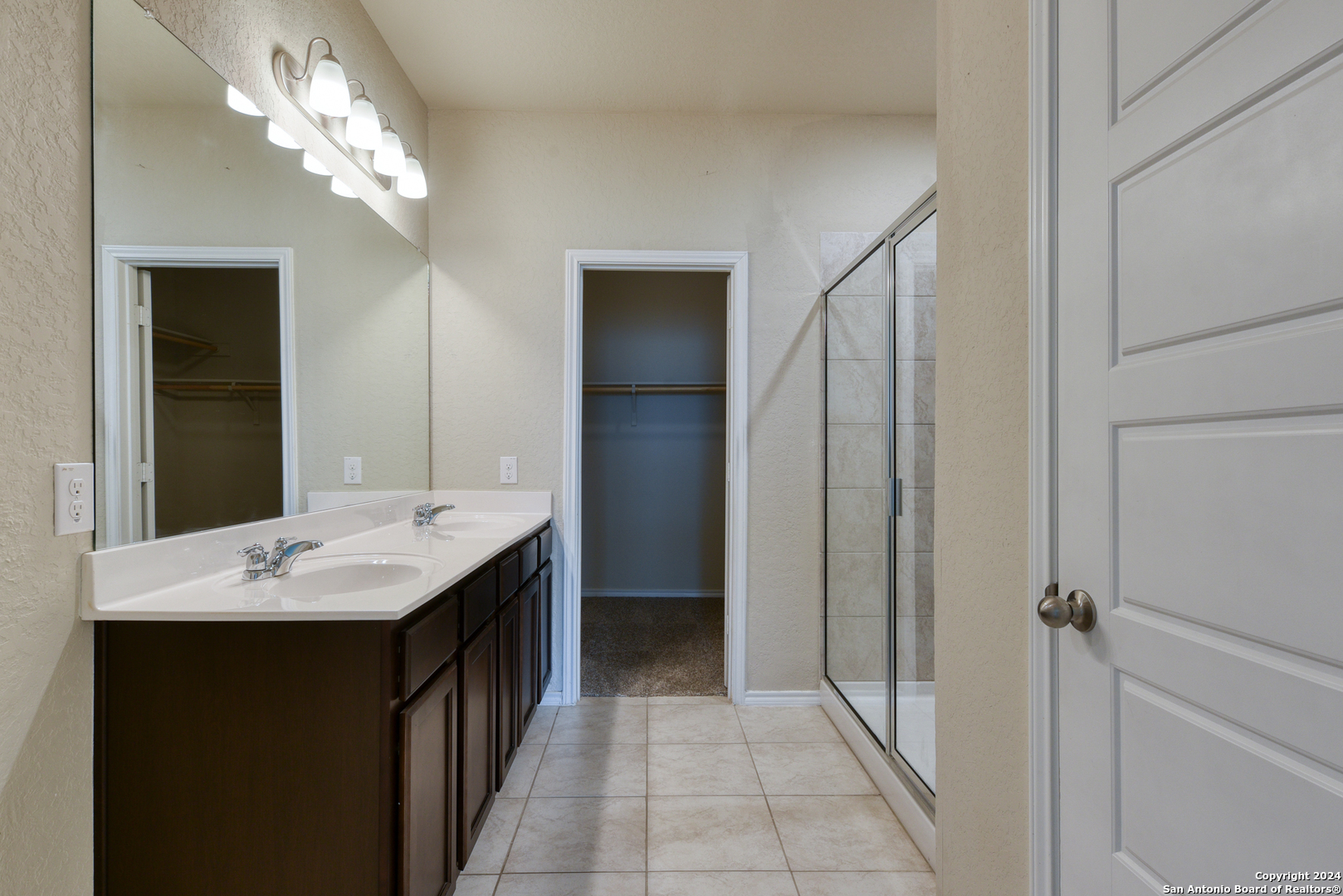 10546 Midsummer Meadow Converse, TX 78109 - Photo 8 of 18 a bathroom with a granite countertop sink a mirror and a shower