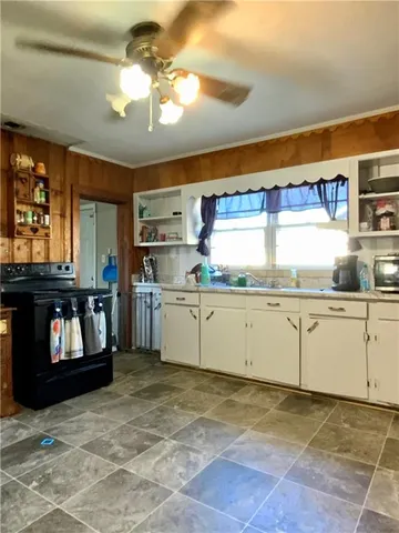 a kitchen with cabinets and window