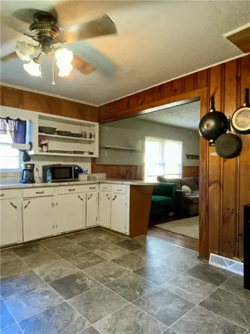 a kitchen with a cabinets and chandelier