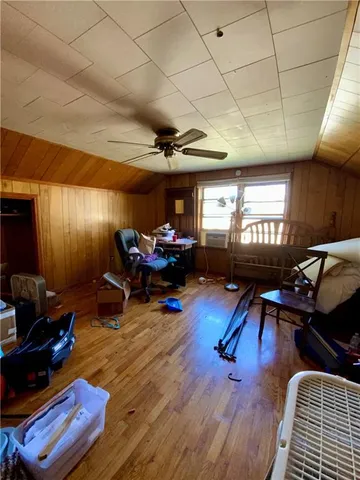 a living room with furniture gym equipment and a fireplace