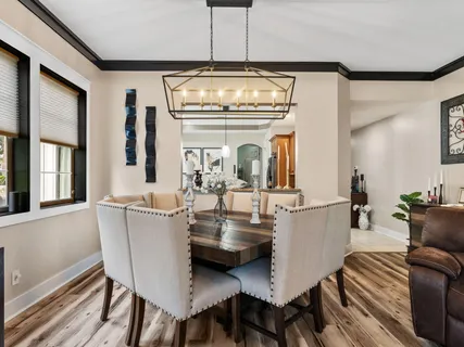 a spacious bedroom with a bed and a chandelier