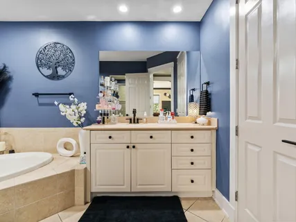 a bedroom with a bed window and a flat screen tv