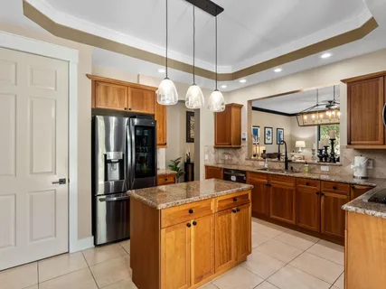 a kitchen with stainless steel appliances granite countertop a stove and a refrigerator
