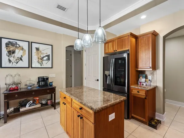 a kitchen with stainless steel appliances granite countertop a sink a stove top oven a counter space and cabinets