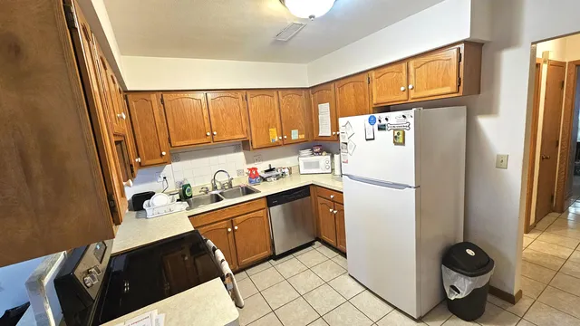 a white refrigerator freezer sitting inside of a kitchen