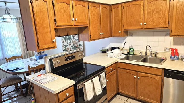 a kitchen with a sink cabinets and appliances