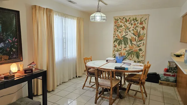 a view of a dining room with furniture and window