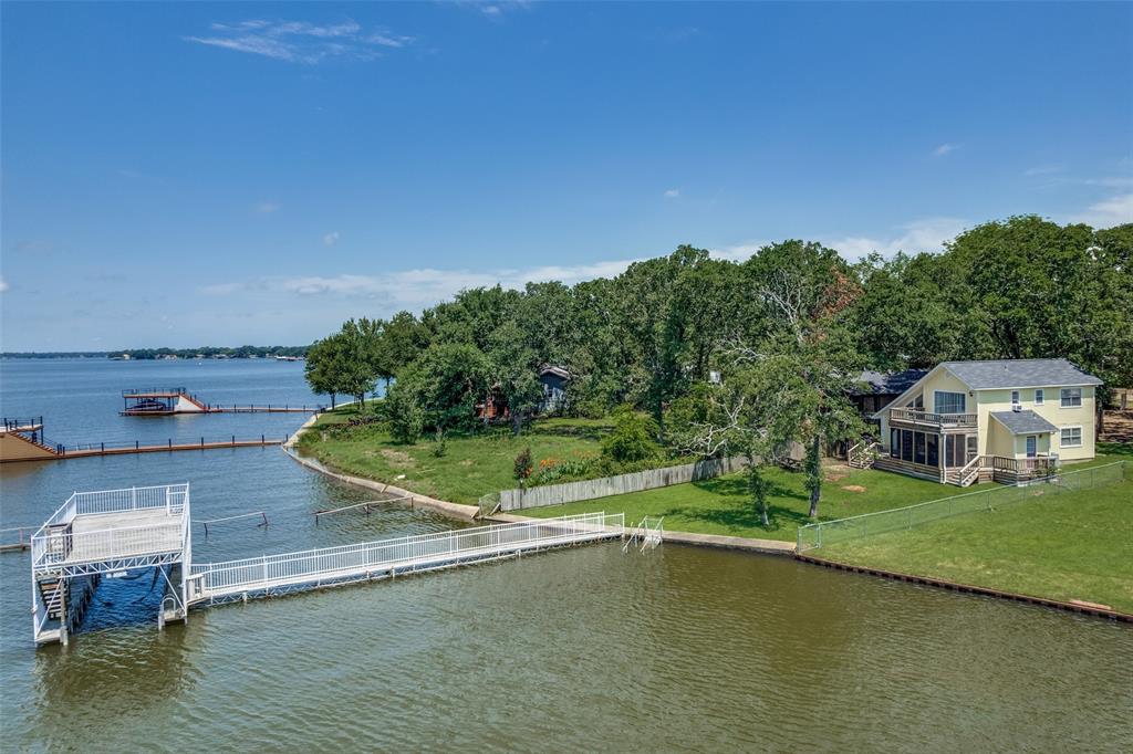 an aerial view of a house with a yard basket ball court and outdoor seating