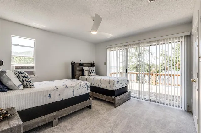 a bedroom with bed and large window
