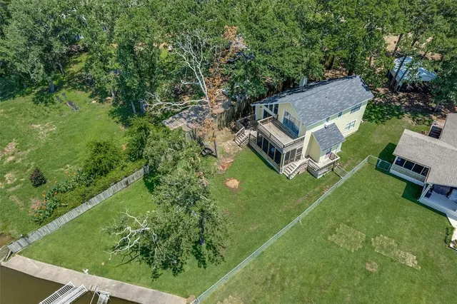 an aerial view of a house with garden space and street view
