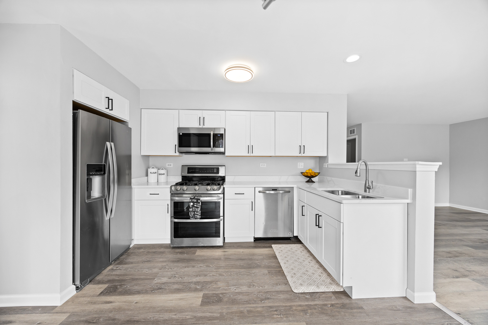 631 Kingsbrooke Crossing Bolingbrook, IL 60440 - Photo 11 of 40 a kitchen with stainless steel appliances a stove refrigerator sink and microwave