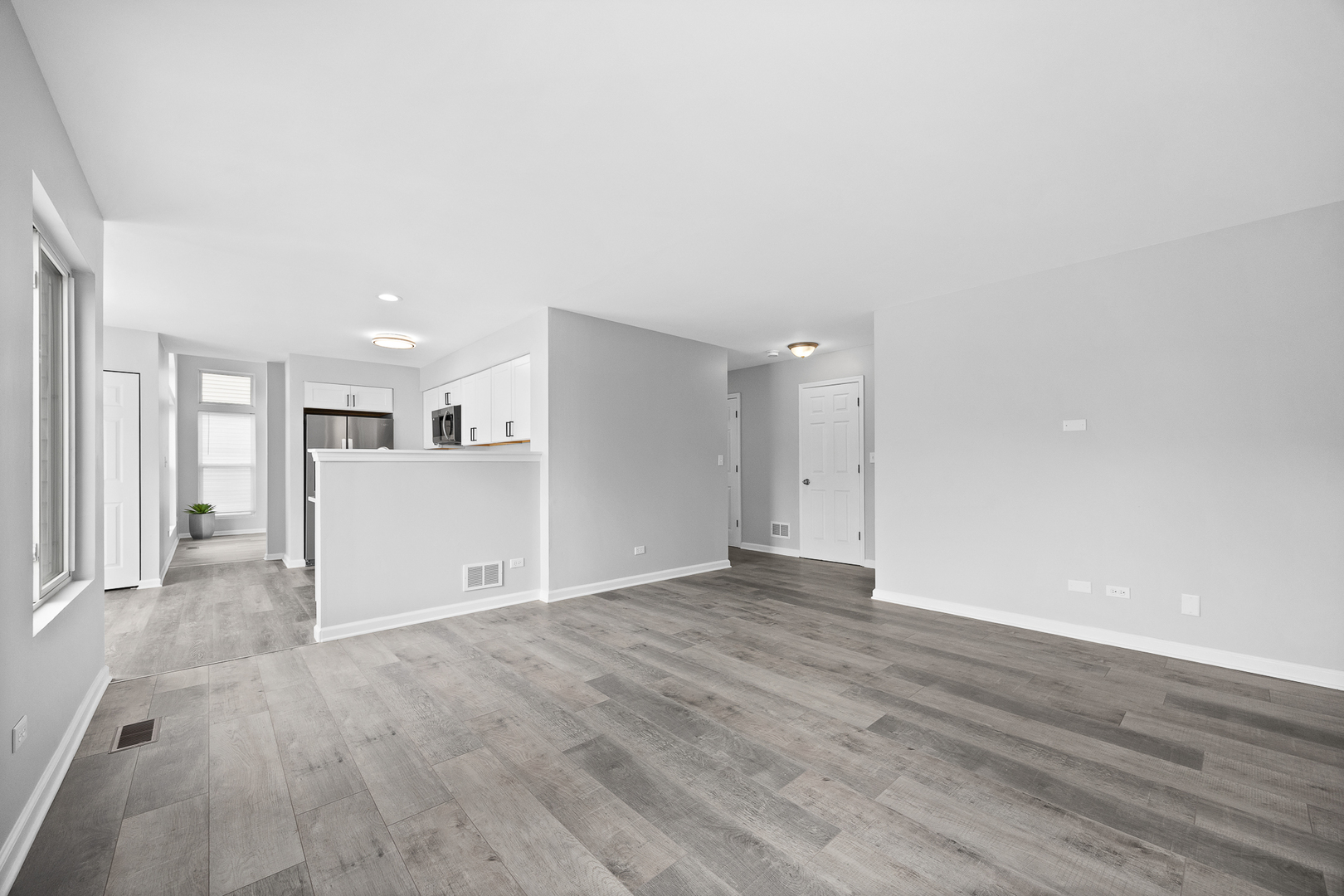 631 Kingsbrooke Crossing Bolingbrook, IL 60440 - Photo 14 of 40 a view of a big room with wooden floor and windows