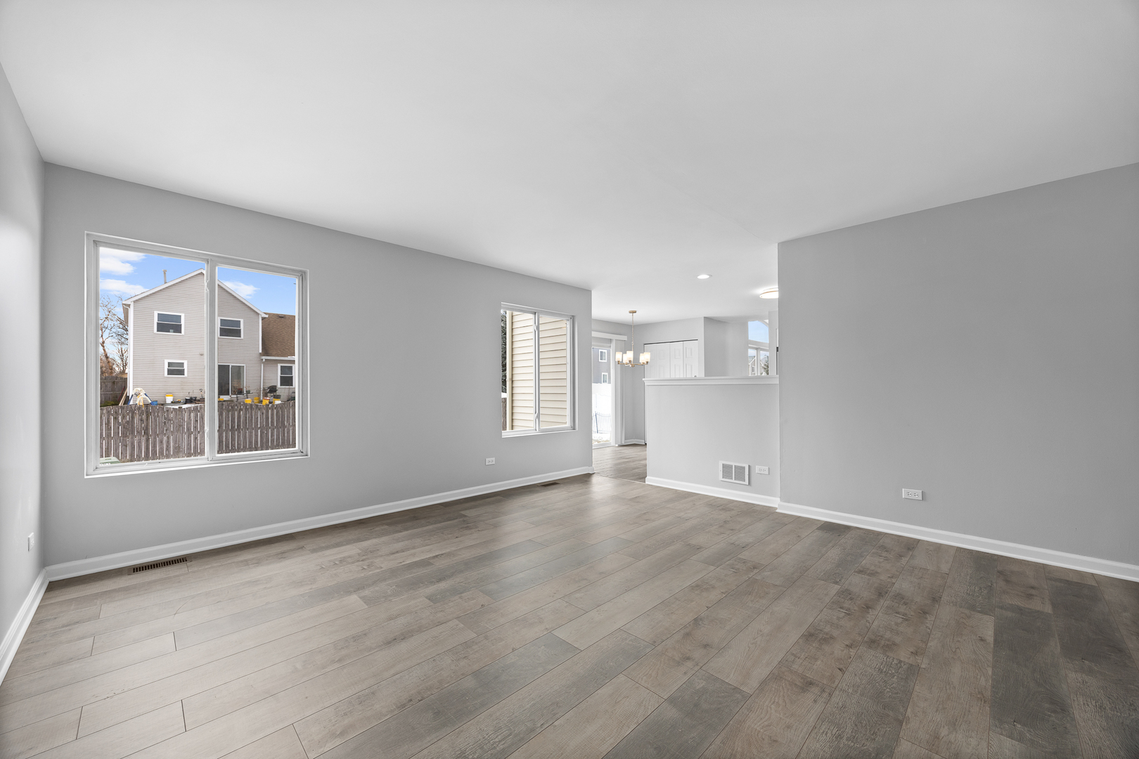 631 Kingsbrooke Crossing Bolingbrook, IL 60440 - Photo 15 of 40 a view of an empty room with a window and wooden floor