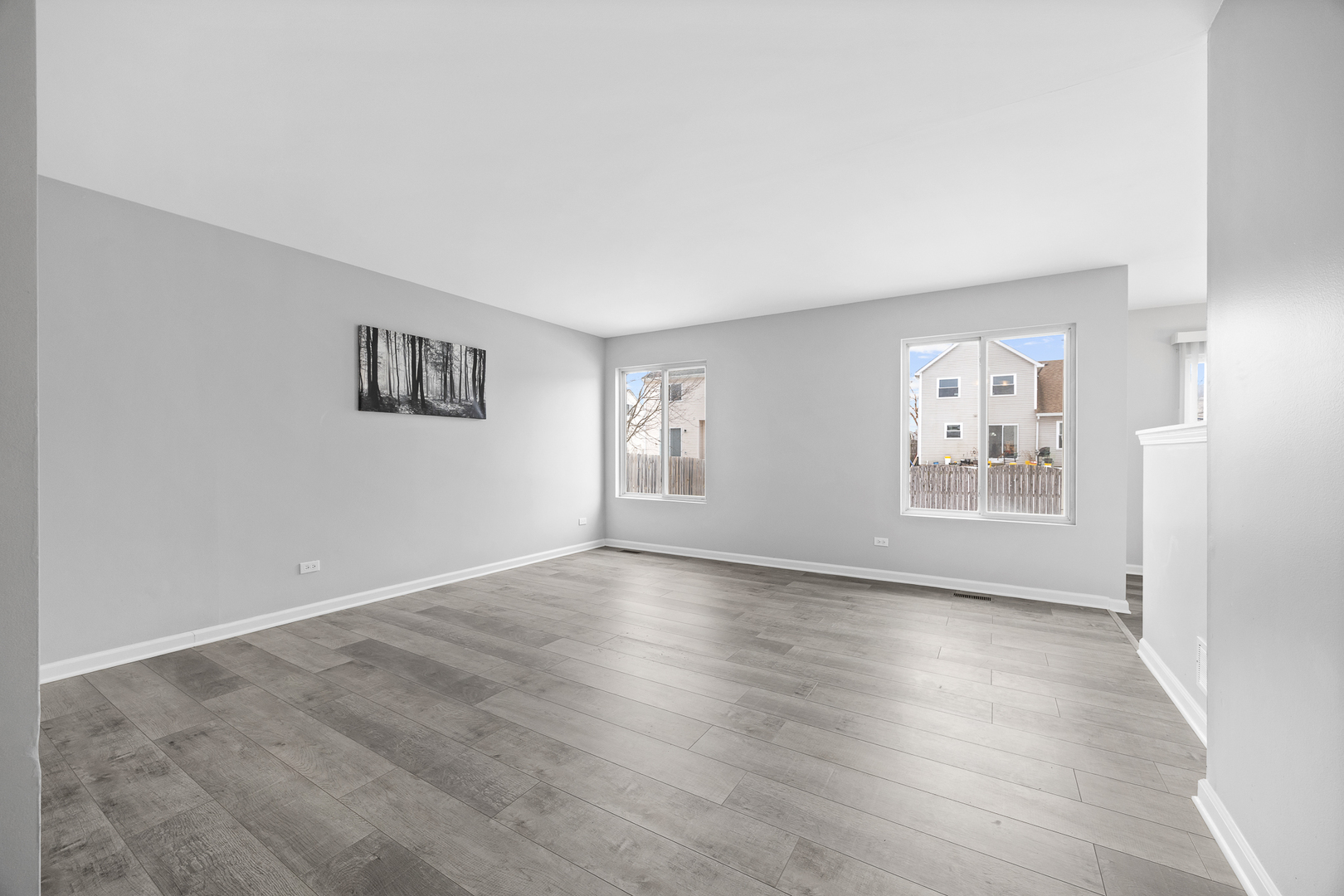 631 Kingsbrooke Crossing Bolingbrook, IL 60440 - Photo 16 of 40 a view of an empty room with a window and wooden floor