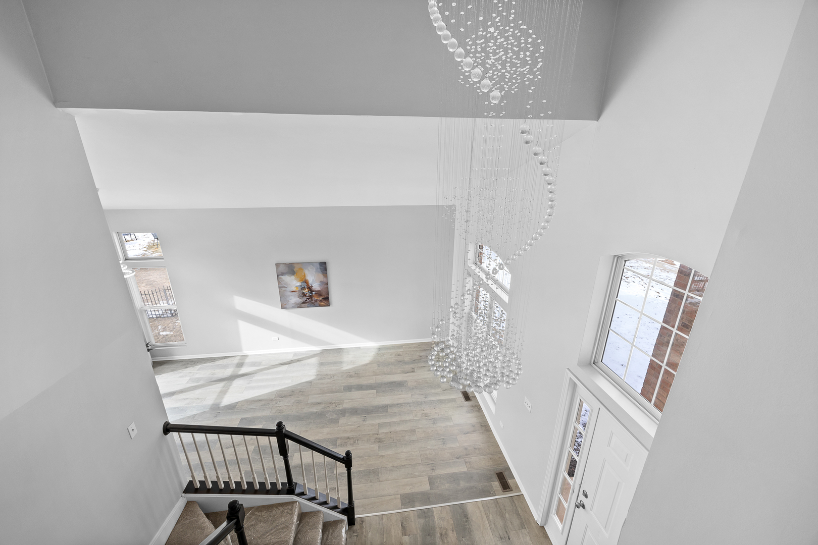 631 Kingsbrooke Crossing Bolingbrook, IL 60440 - Photo 19 of 40 a view of a livingroom with wooden floor and a hallway