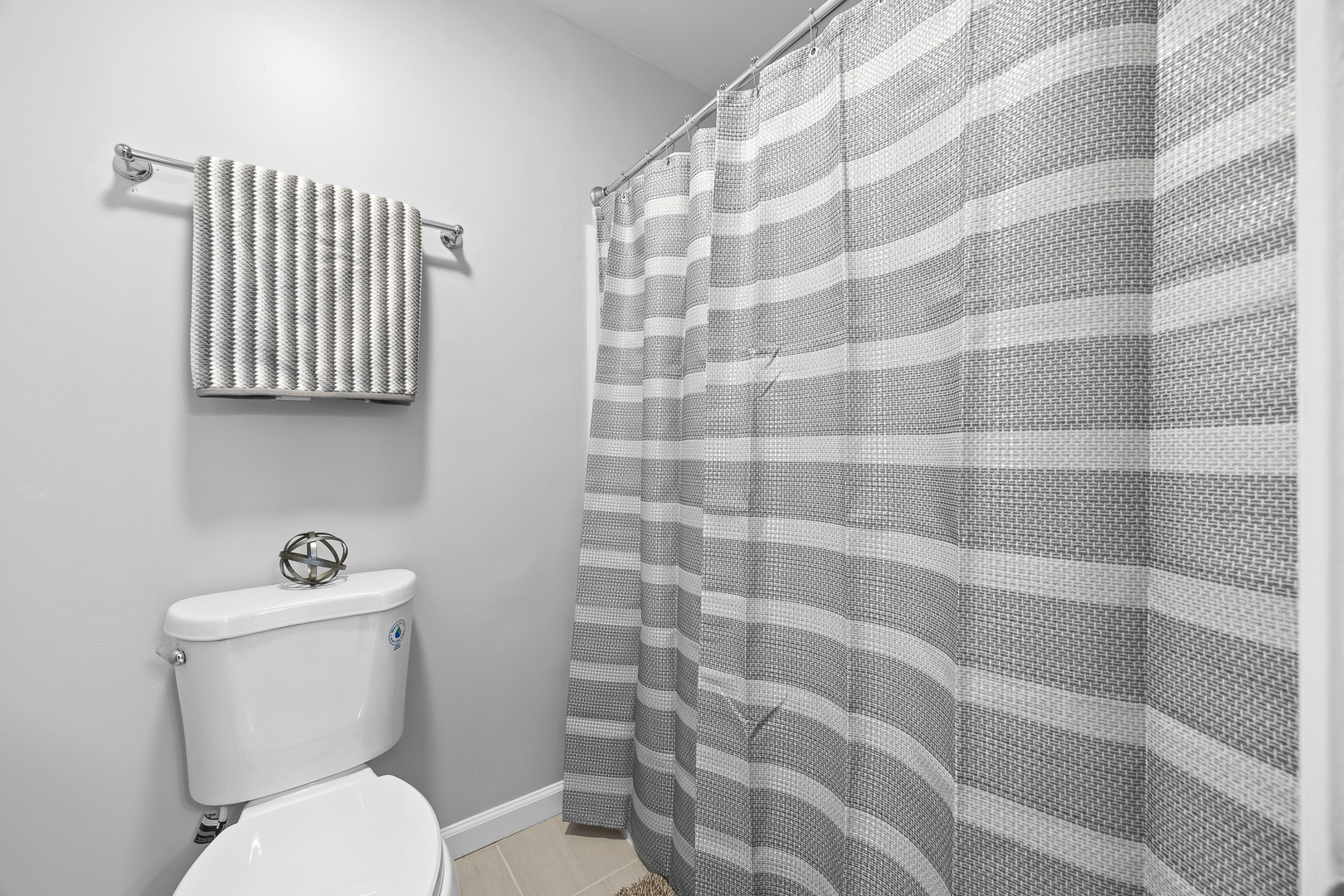 631 Kingsbrooke Crossing Bolingbrook, IL 60440 - Photo 30 of 40 a white toilet sitting next to a shower curtain