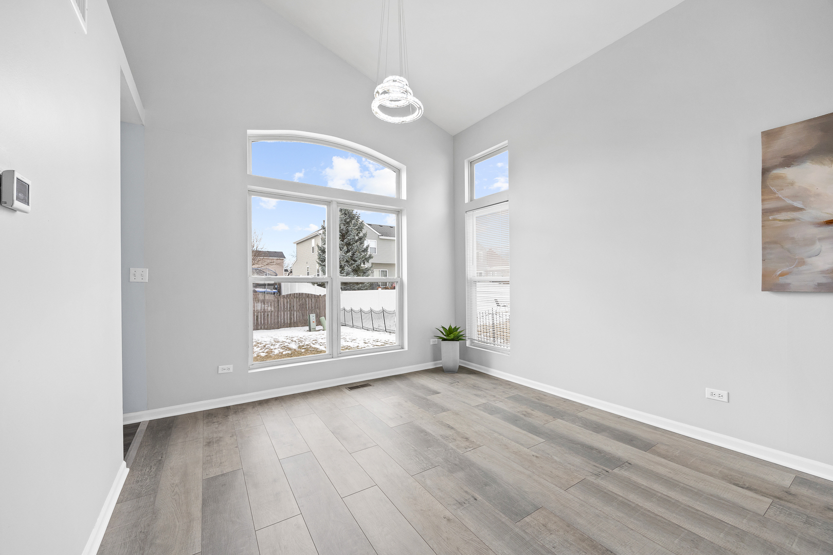631 Kingsbrooke Crossing Bolingbrook, IL 60440 - Photo 9 of 40 an empty room with wooden floor and windows