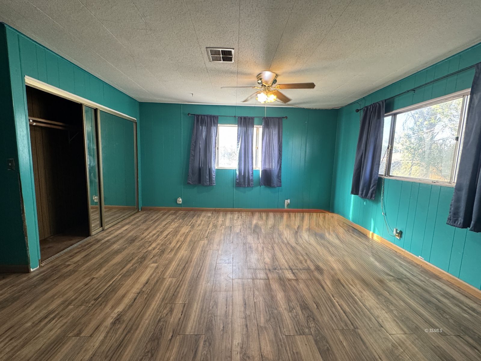 1320 South Brady Street Ridgecrest, CA 93555 - Photo 11 of 29 wooden floor in an empty room with a window