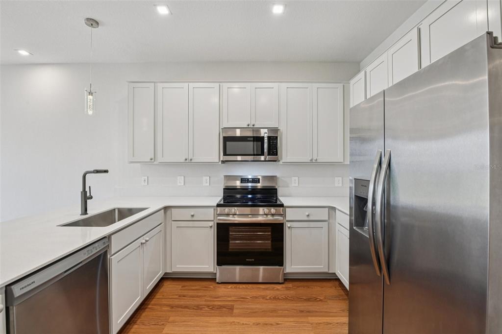 6159 Peaceful Pk Way Clermont, FL 34714 - Photo 15 of 43 a kitchen with a sink stove and refrigerator