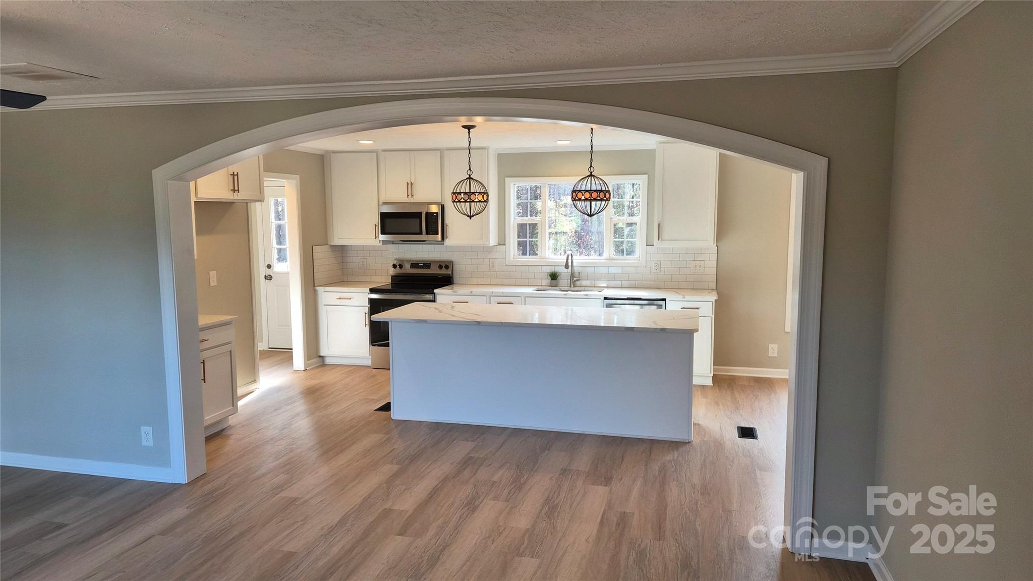 680 Tirzah Church Road Lancaster, SC 29720 - Photo 2 of 25 a room with kitchen island granite countertop wooden floors and wide window
