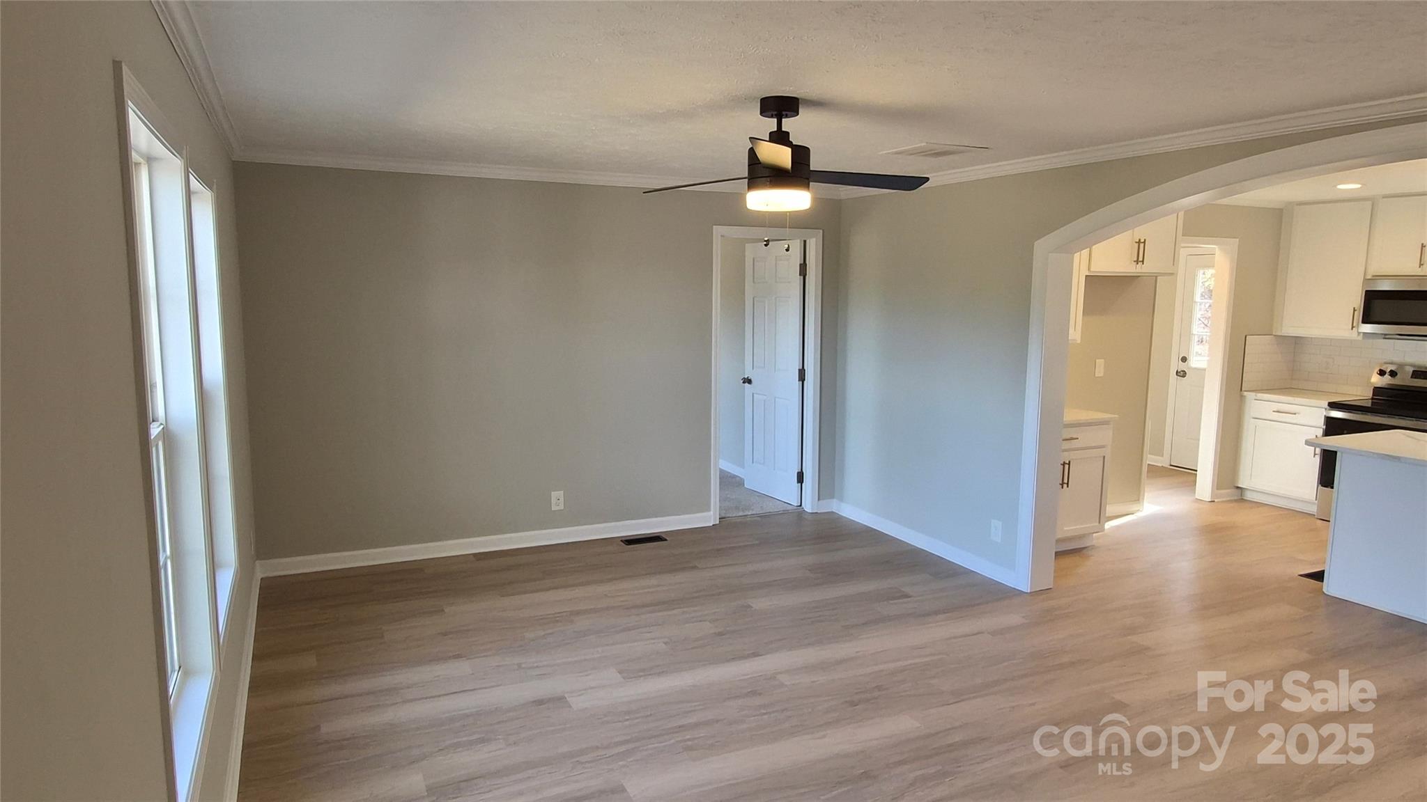 680 Tirzah Church Road Lancaster, SC 29720 - Photo 3 of 25 a view of empty room with wooden floor and fan