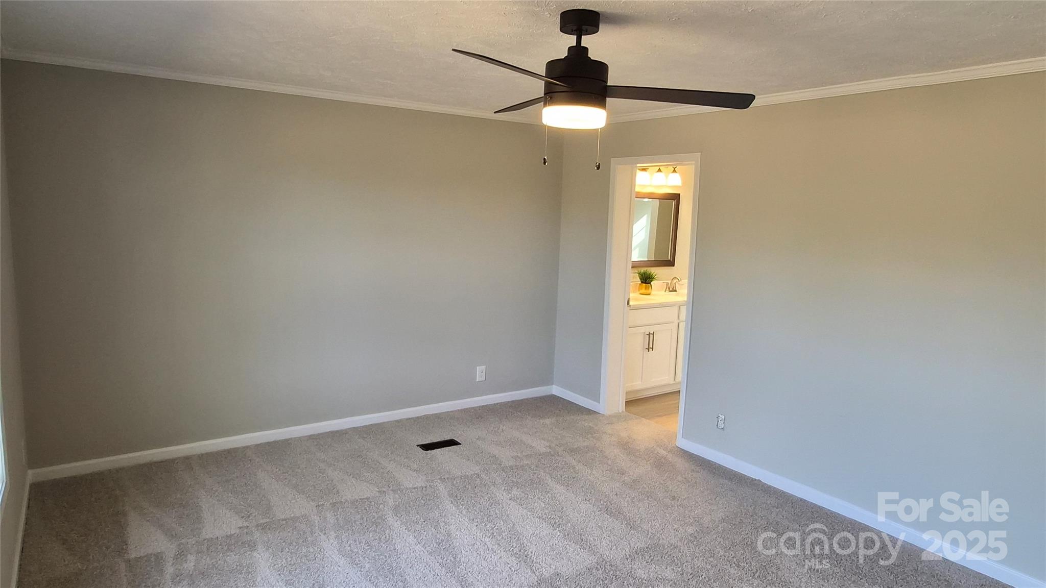 680 Tirzah Church Road Lancaster, SC 29720 - Photo 8 of 25 an empty room with a chandelier fan and a window