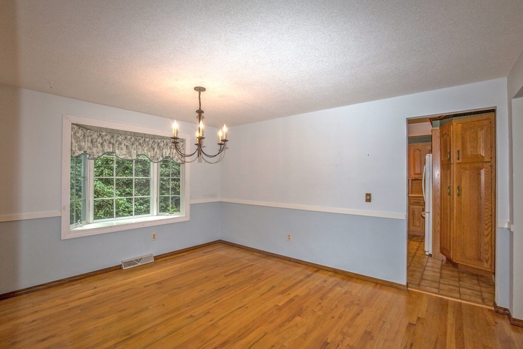 477 Wolf Swamp Road Longmeadow, MA 01106 - Photo 13 of 35 an empty room with wooden floor and windows