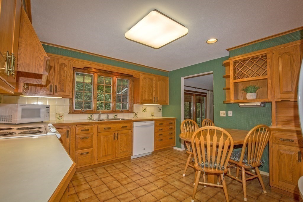 477 Wolf Swamp Road Longmeadow, MA 01106 - Photo 14 of 35 a kitchen with a stove a sink and a refrigerator