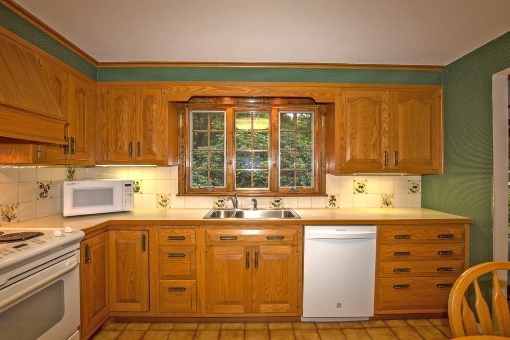 477 Wolf Swamp Road Longmeadow, MA 01106 - Photo 15 of 35 a kitchen with a sink stove and cabinets