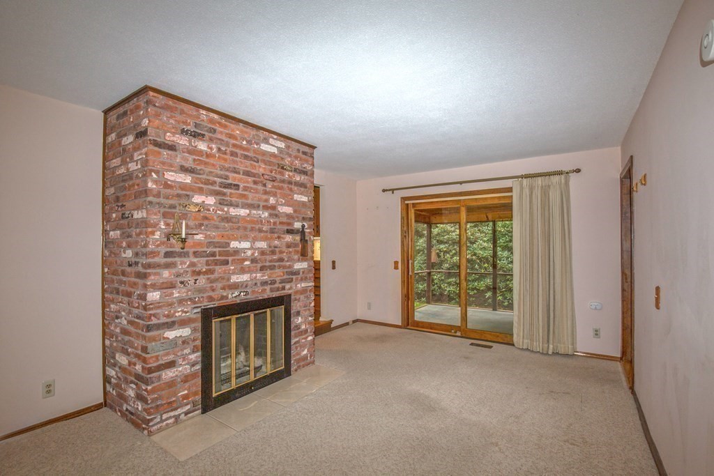 477 Wolf Swamp Road Longmeadow, MA 01106 - Photo 19 of 35 a view of an empty room with a fireplace and a window