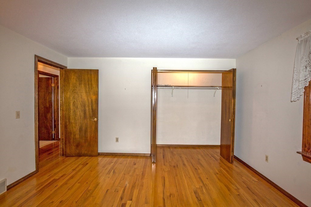 477 Wolf Swamp Road Longmeadow, MA 01106 - Photo 25 of 35 an empty room with wooden floor and closet